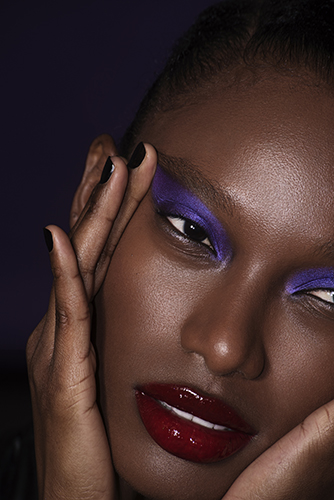 black model wearing purple make up